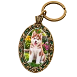 Antique-brass and green enamel oval keychain framing the husky puppy